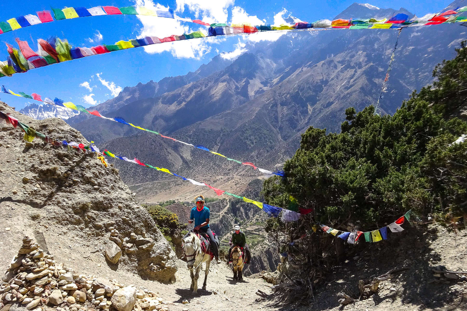 Trail riders riding up the Himalayas on horseback