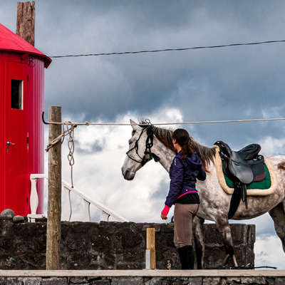 Rider, horse and red mill on Faial Island