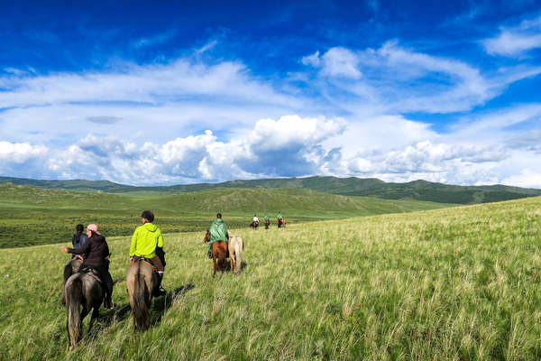 A group of riders riding across Khentii in Mongolia