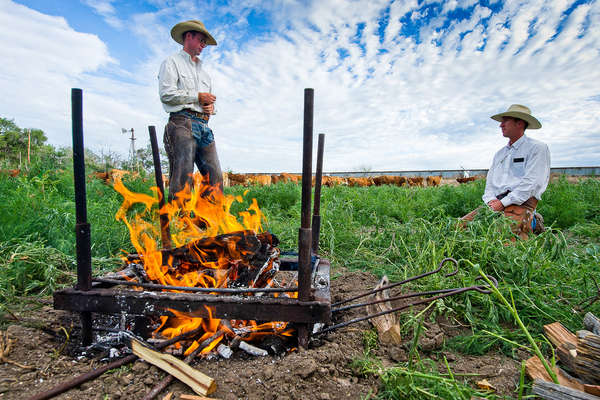 Cowboys getting the firepit ready for a branding day at Chico Basin ranch, Colorado