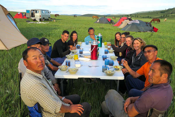 Group of horseback riders getting ready for dinner in Mongolia