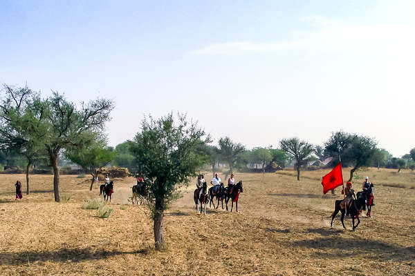 Group of riders in a field in India on horseback