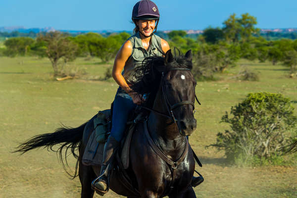 Happy rider on a horseback safari