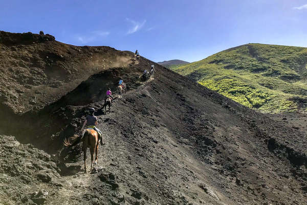 Horseback riders climbing the foothills of Mt Etna