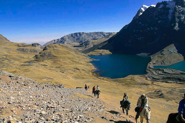 Horseback riding across the mountain range in Peru