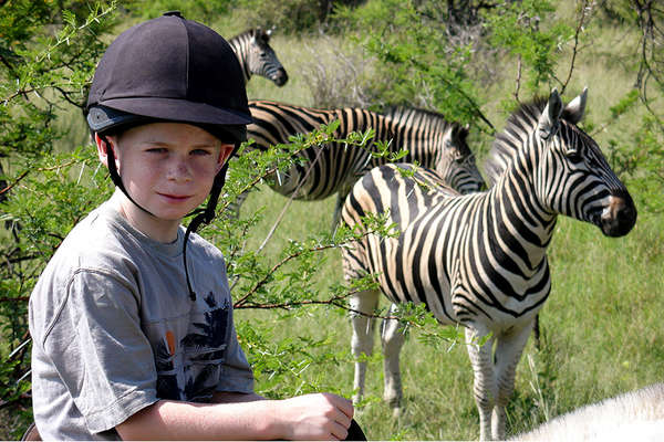 Horseback riding safari in South Africa with zebras
