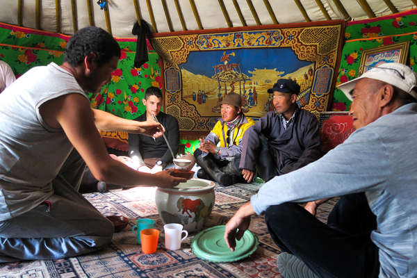 Nomads welcoming visitors to their yurt
