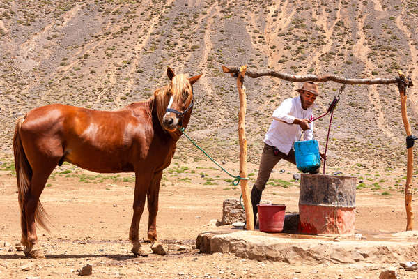 Rider watering his horse at a well in the Atlas mountains