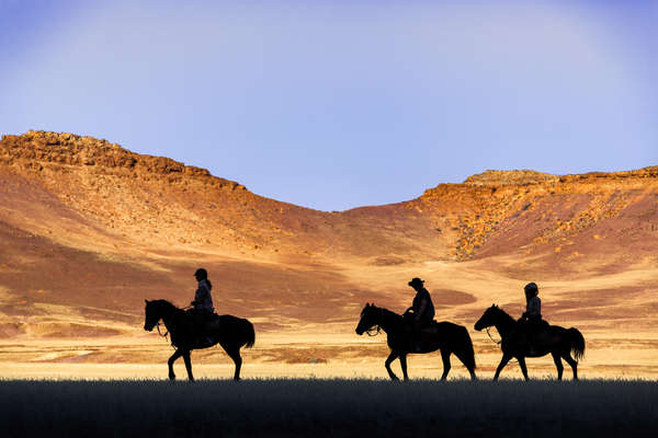 Riders crossing Damaraland on a horseback expedition, Namibia