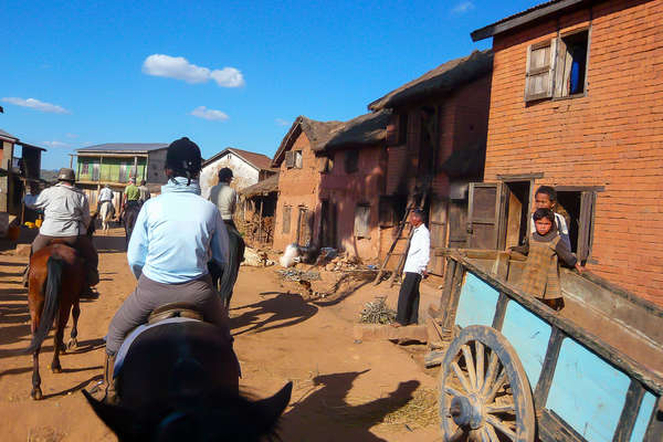 Riders going through a town in Madagascar