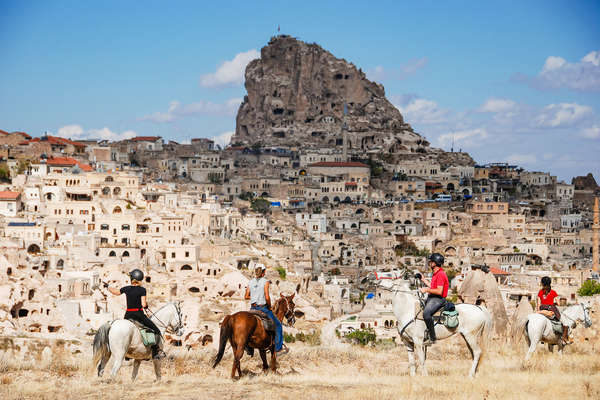 Riders in front of troglodyte villages in Turkey