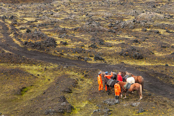 Riders on foot next to their horses in Landmannalaugar