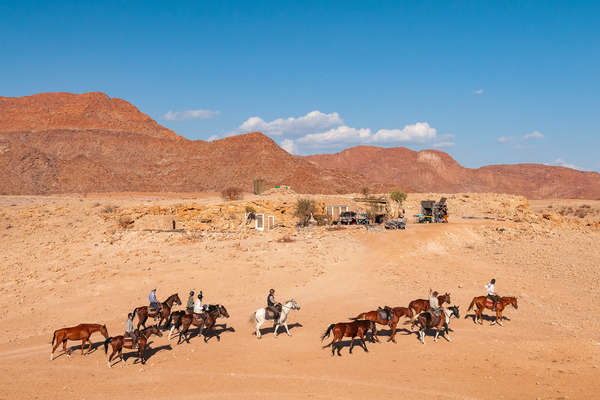 Riders on horseback in the Namib desert