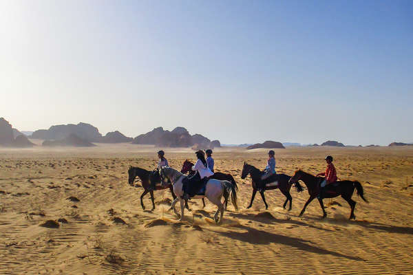 Riders riding in a desert in Jordan