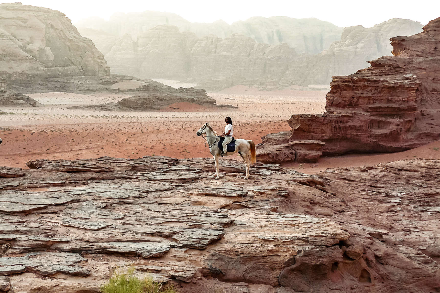 Horse and rider in the Wadi Rum desert, Jordan