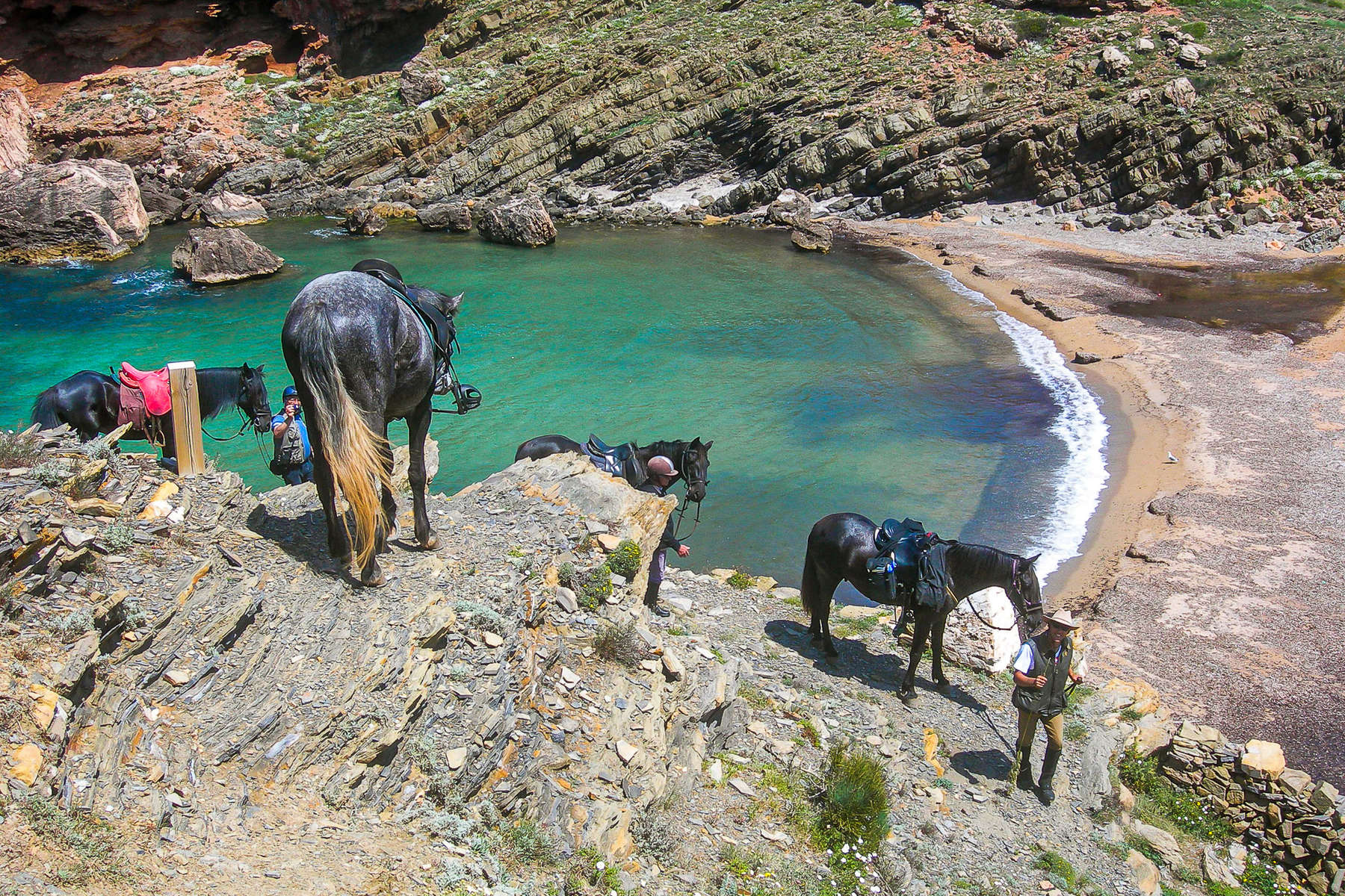 Trail riding in Menorca Horses riding down to a beach in Menorca