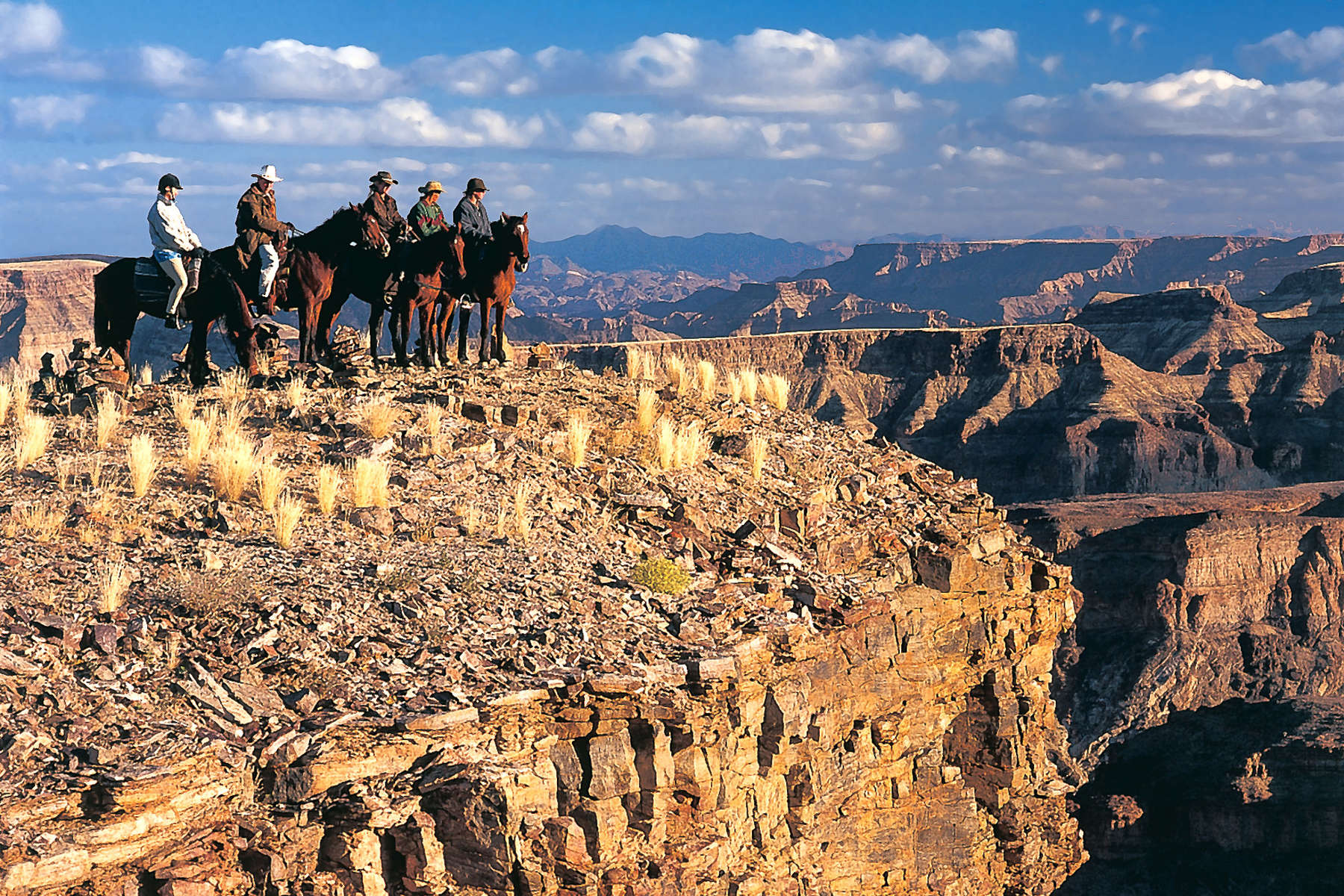 Journey through Namibia's Fish River Canyon on horseback