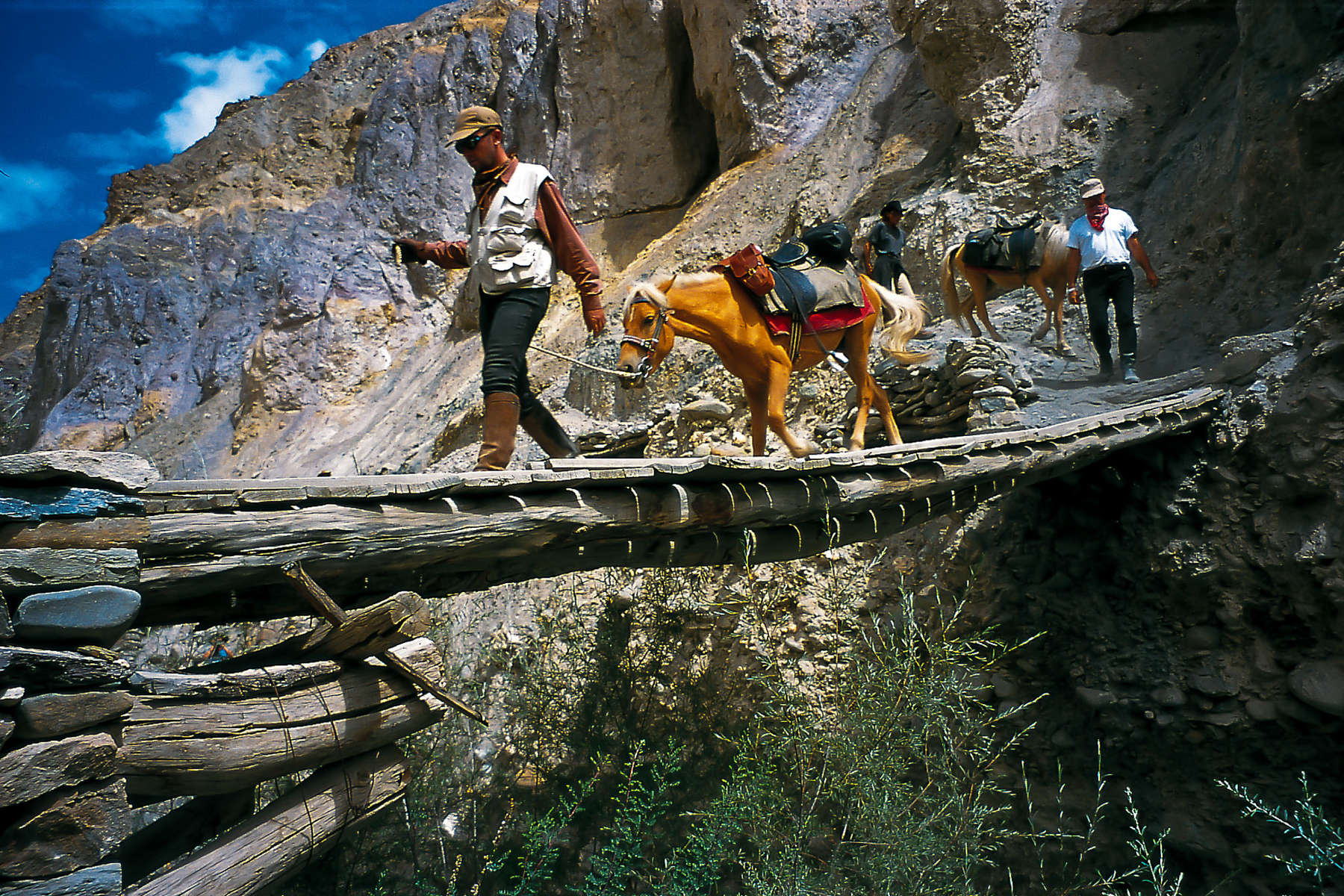 Rider and horse crossing a bridge in Ladakh, India