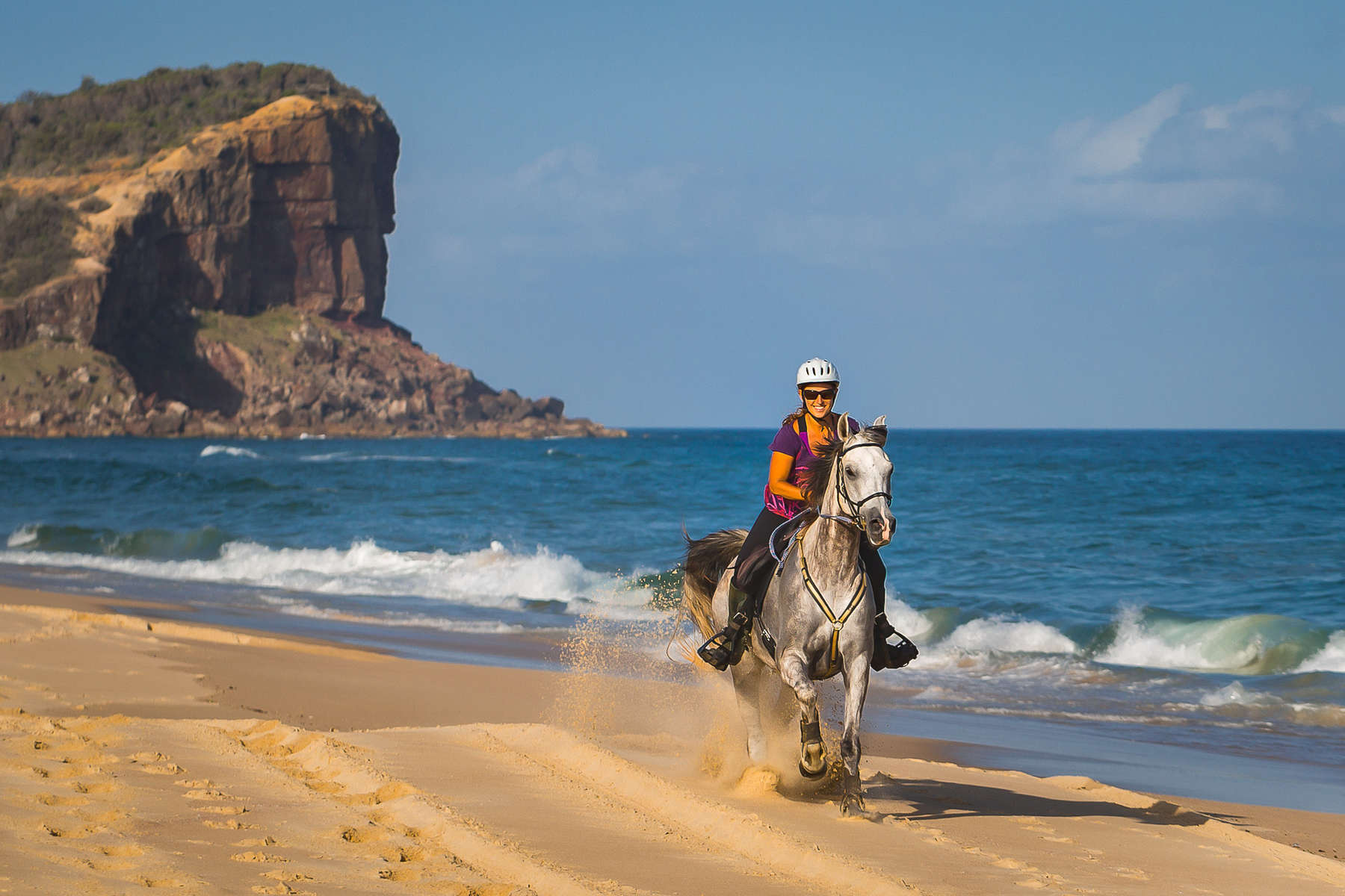 Rider cantering on an Arabian horse on an Australian beach