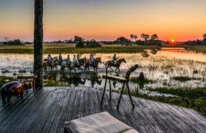 Riders at sunset in  the Okavango Delta