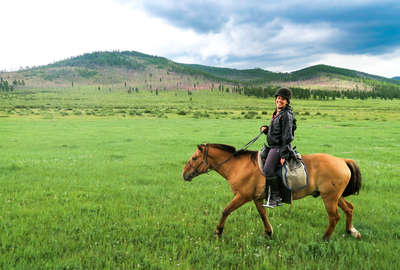 A rider smiling at the camera in Mongolia