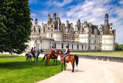 Chambord castle and horseback riders