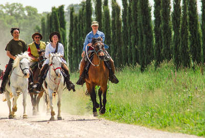 Group of horseback riders in Tuscany, Italy