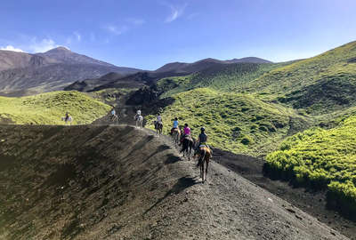 Horseback riders on a trail ride to Mount Etna