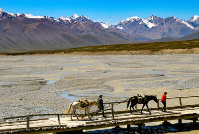 Rider and horse crossing a bride, Kyrgyzstan