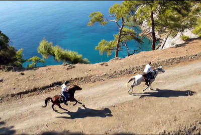 Riders cantering along a off the beaten track in Turkey