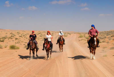 Riders in the Arabian Desert