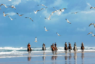 Riders on a beach riding holiday near Bordeaux, France