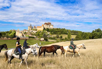 Riders riding in front of medieval castles in France