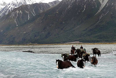 River crossing on horseback in New Zealand 