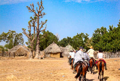 Senegal trail riders entering a village