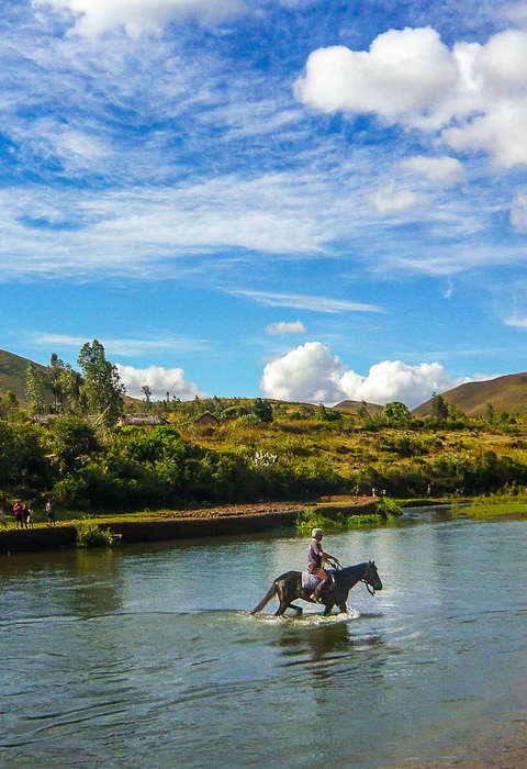 Rider crossing a river in Madagascar