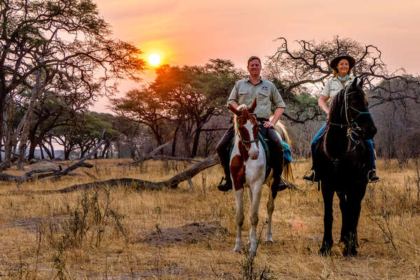 A couple of riders riding in the Zimbabwen sceneries