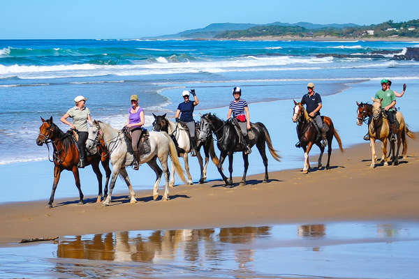 A group of riders on the beach, in South Africa