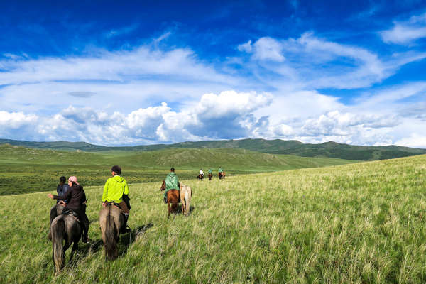 A group of riders riding across Khentii in Mongolia