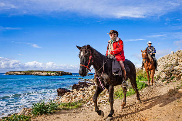 A group of trail riders riding Menorcan horses on a riding holiday in Menorca