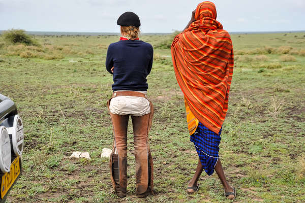 Horseback rider and Masai standing side by side