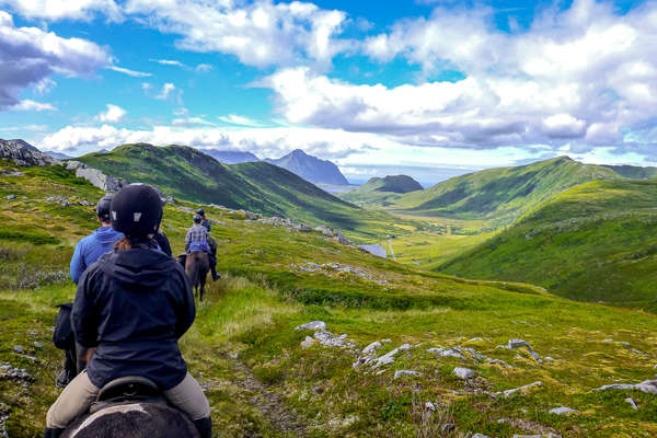 Horseback riders enjoying a trail ride in Gimsøy in the Lofoten Islands