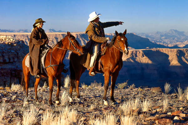 Horseback riders in Namibia looking into the distance