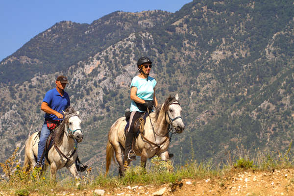 Horseback riders on a mountain trail ride in Albania