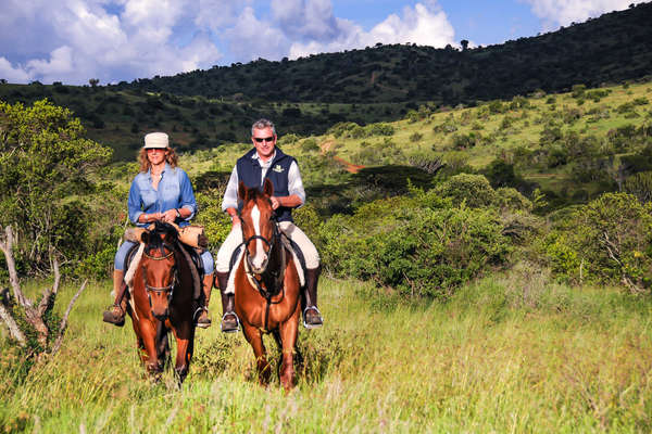 Horseback riders riding in the wilds of Borana Lodge in Kenya