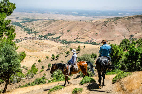 Horseback riders travelling across the Atlas, Morocco