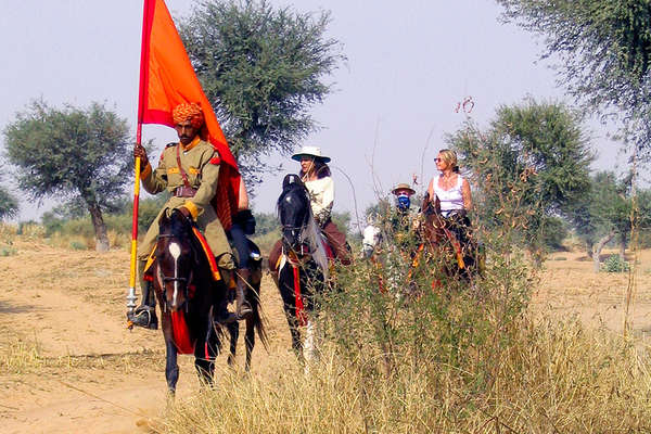 Horses and riders in indian desert
