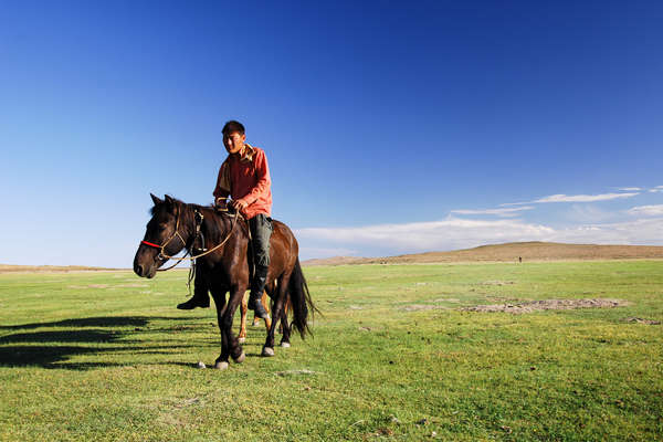 Mongol rider on horseback across the Orkhon Valley