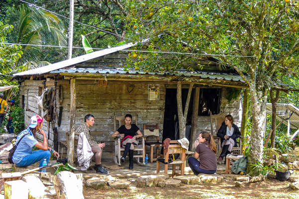 People chatting on a porch in Cuba