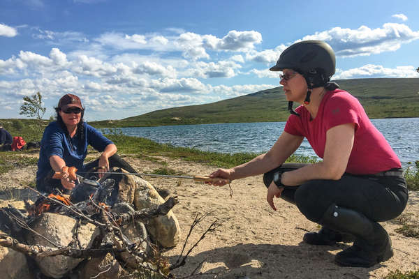 Preparing a fire after a day of horseback riding in Finland